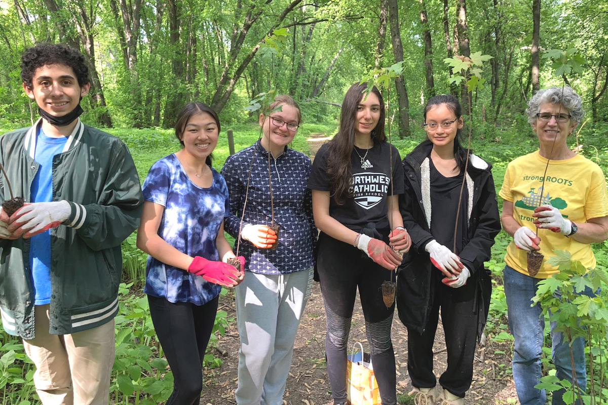 CRC restoration volunteers with trees for planting