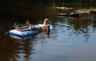 "Paddling" out onto 4th CT Lake on a Pool Raft, by Tim Lewis