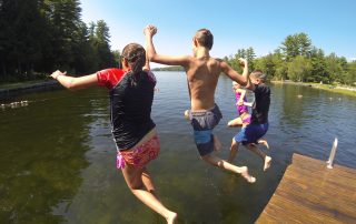 People jumpingoff a dock in to the Connecticut River