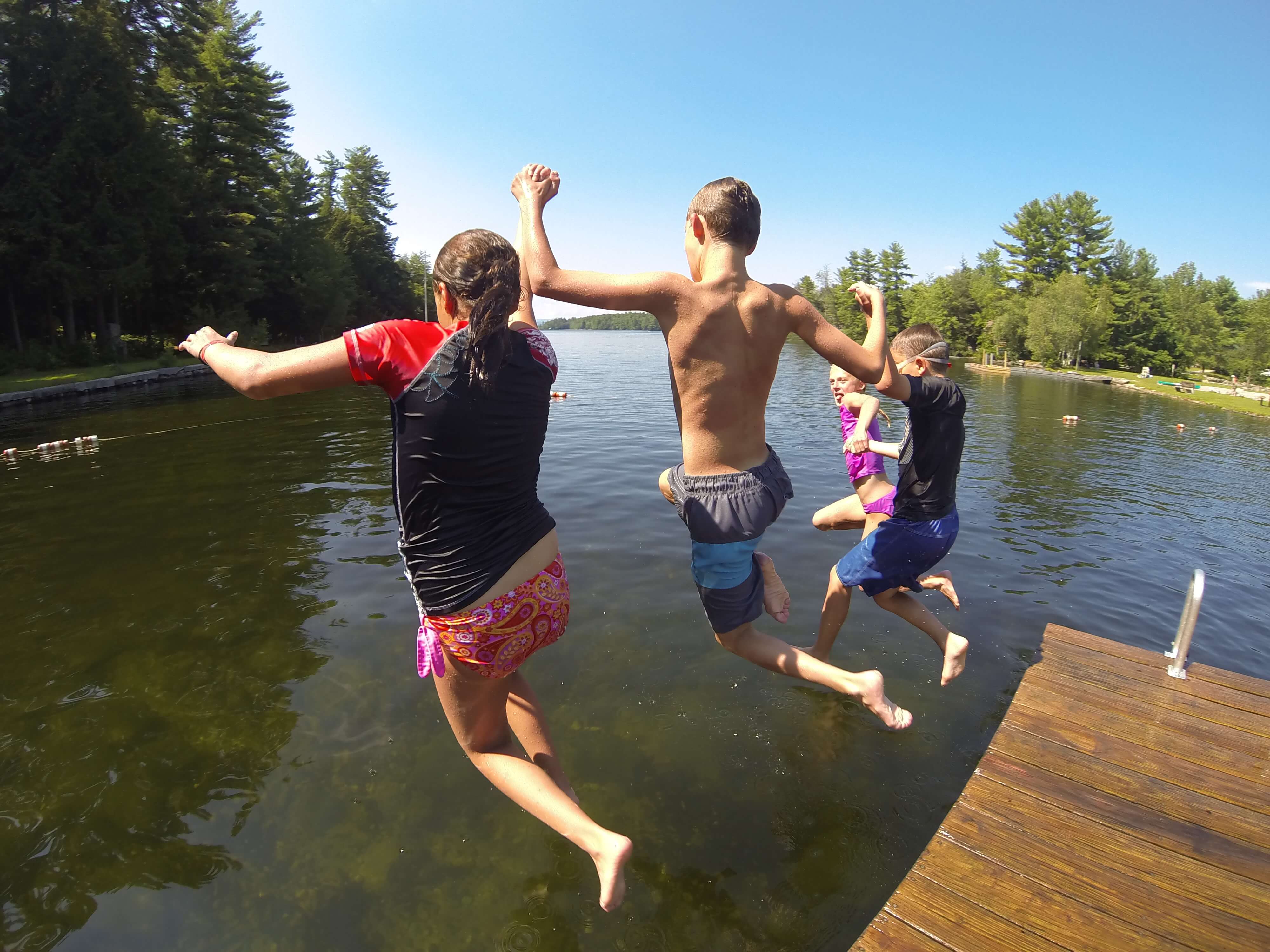 People jumpingoff a dock in to the Connecticut River